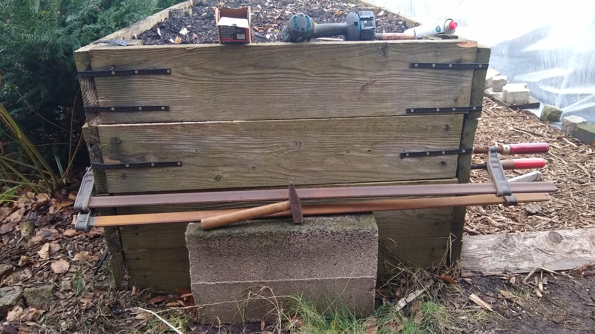 raised bed with rotten posts braced with clamps