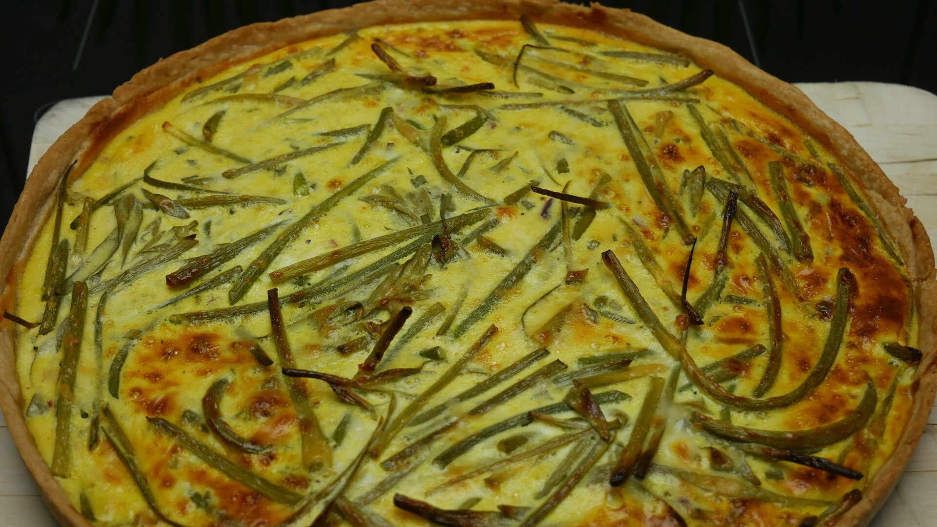 quiche made with garlic flowers and tarragon shoots