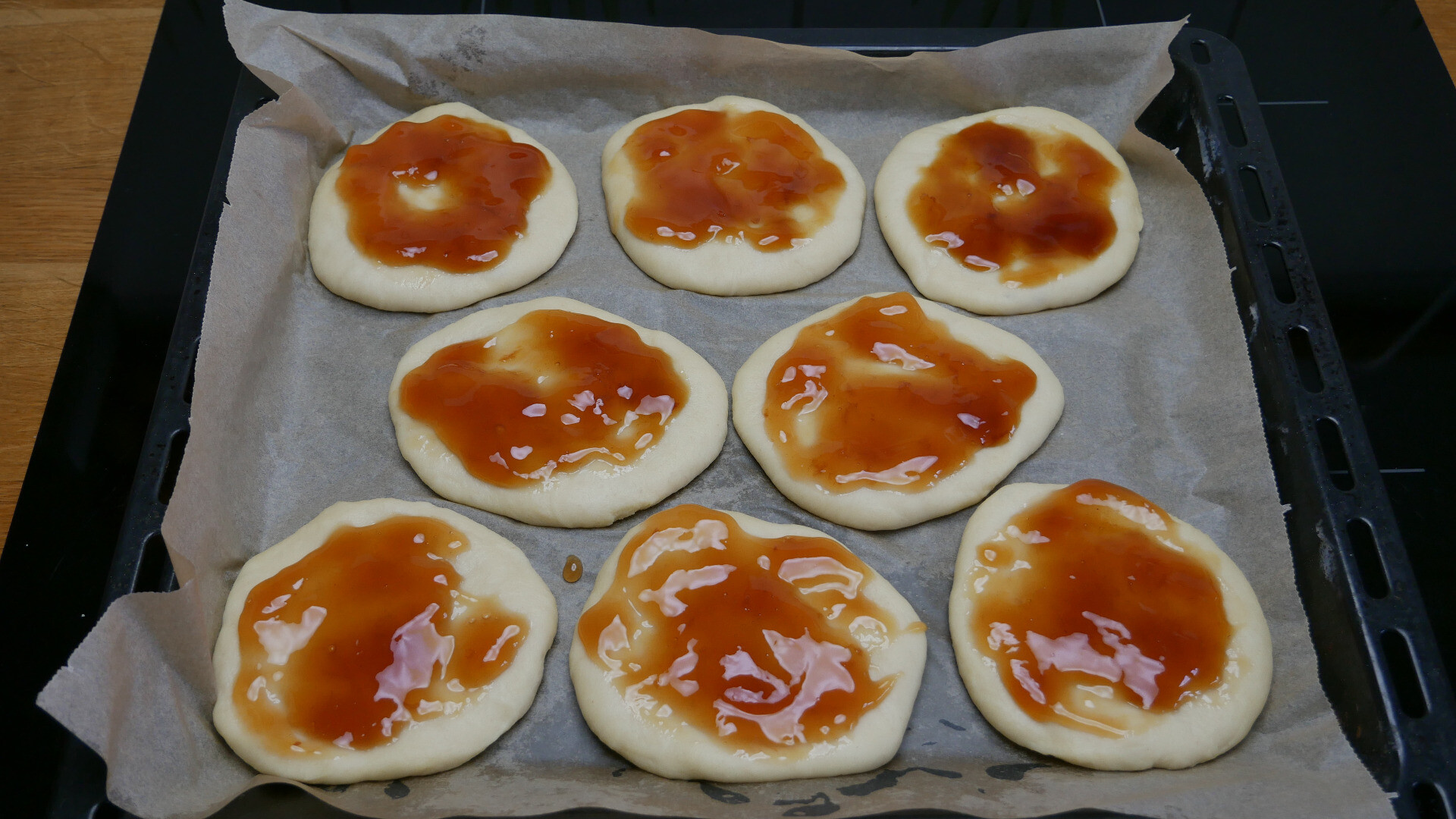 flattened dough with spread of quince jelly