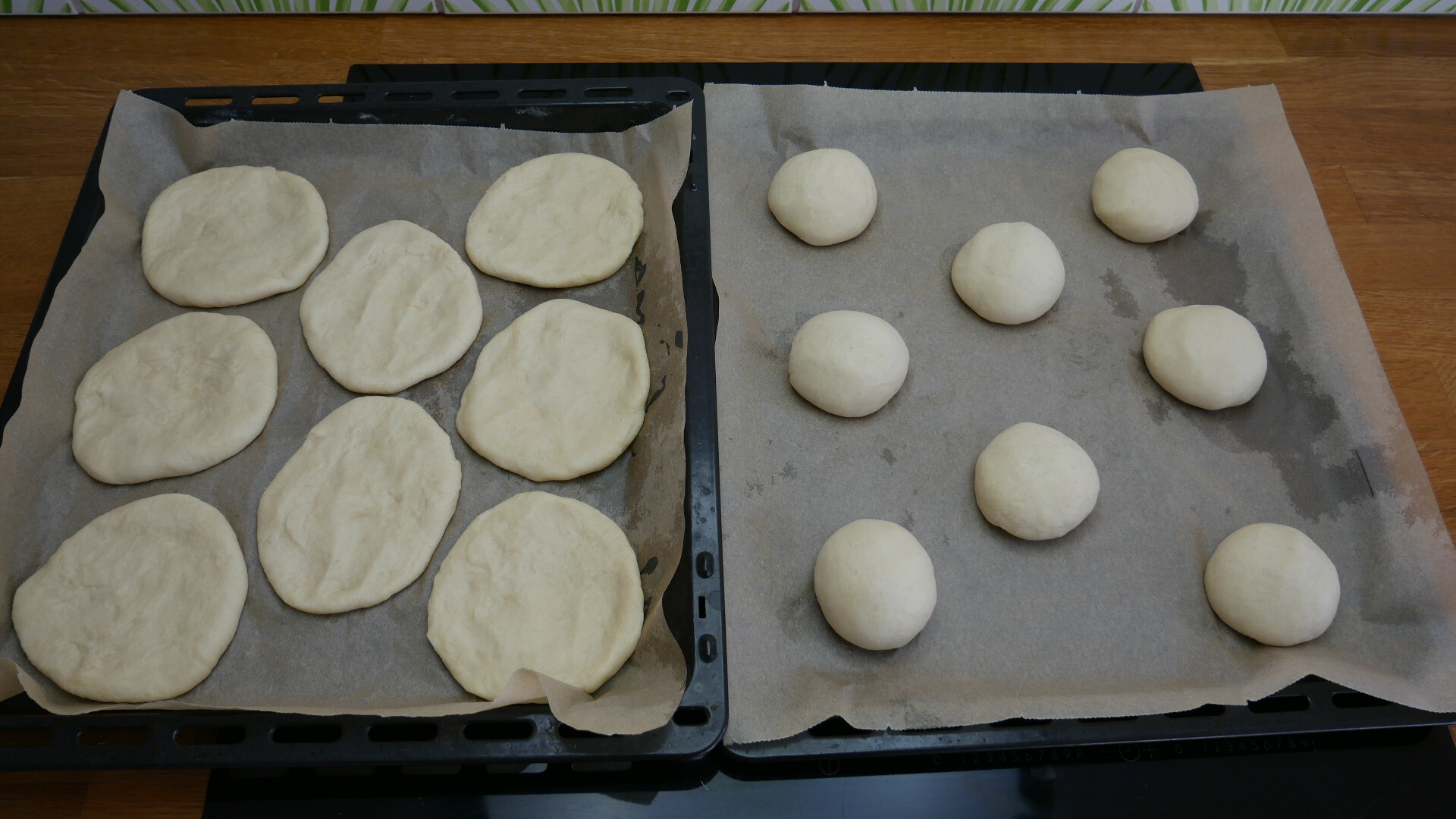 Discs and balls of yeast dough on a baking tray.