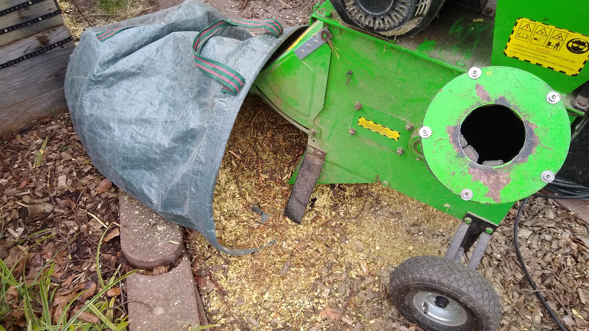 wood chipper with wood chip in a bag